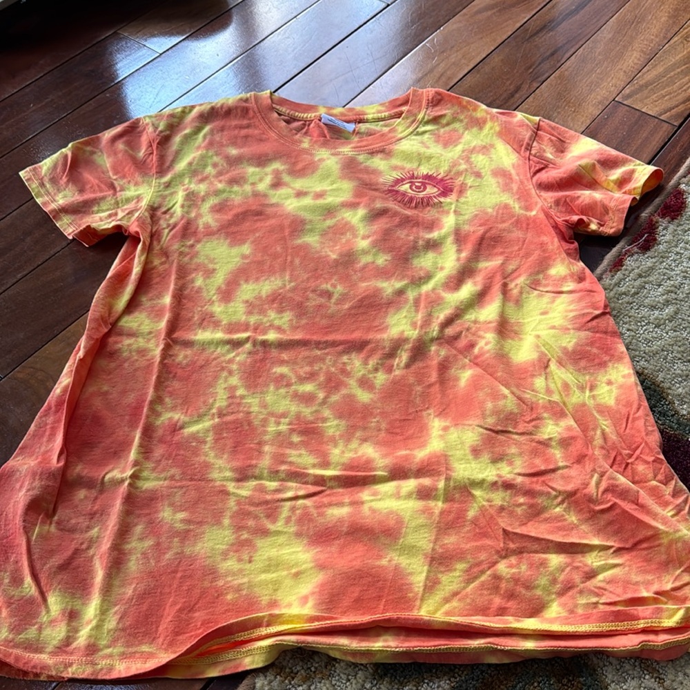 Yellow and orange tie dye t-shirt with cooler eye and flower design.